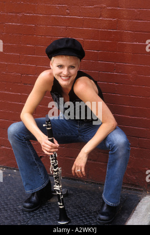 Young woman holding flute, portrait Banque D'Images