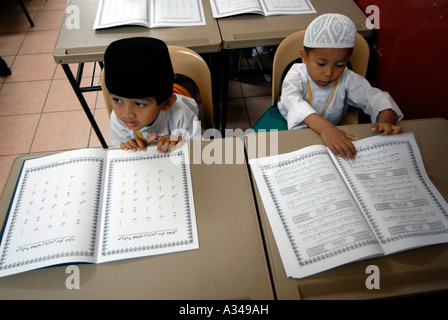 Les élèves de maternelle et primaire une étude d'une version simplifiée du Coran dans une école musulmane, Kuala Lumpur, Malaisie Banque D'Images