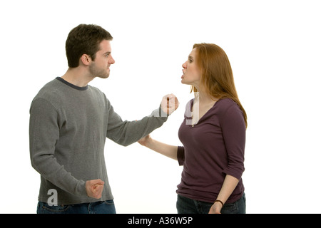 Young couple having an argument. Elle est criant et il a l'air furieux avec les poings serrés. Banque D'Images