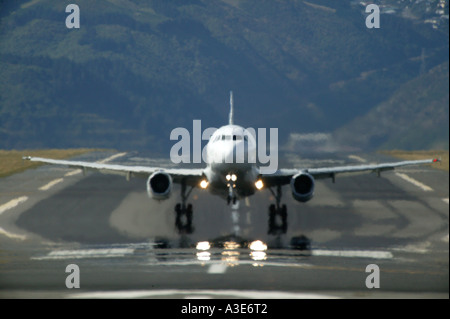 Airbus A320 d'Air NZ décollant de l'Aéroport de Wellington, à la recherche, le long de la piste avec Brume de chaleur, Nouvelle-Zélande Banque D'Images