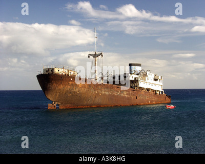 Hulk de rouille d'un bateau dans une mer bleue en Lanzarote Banque D'Images