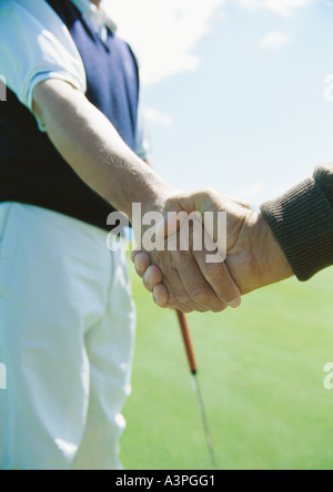 Golfers shaking hands Banque D'Images