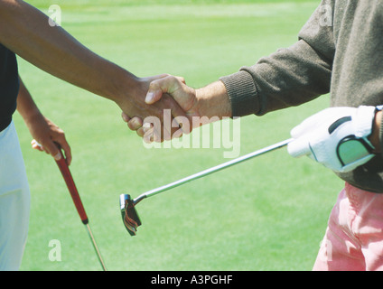Golfers shaking hands Banque D'Images