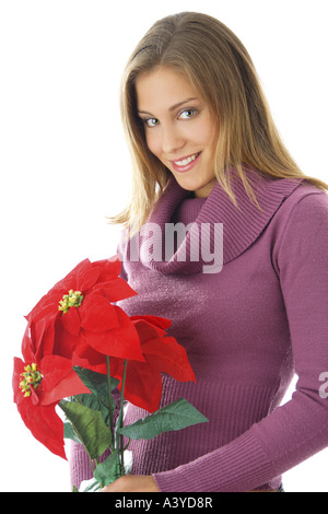 Poinsettia (Euphorbia pulcherrima), jeune femme avec poinsettia Banque D'Images