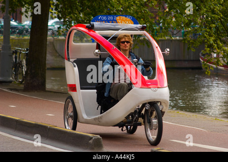 Vélo-taxi à trois roues sur une route du centre-ville d'Amsterdam. Pays-Bas. Banque D'Images