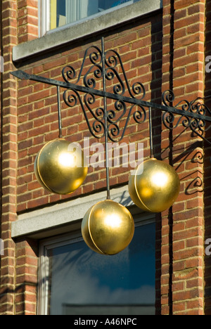 Close up of Pawn Shop signe traditionnel de trois boules d'or au-dessus de prêteur sur gage locaux commerciaux pris en charge sur le support en fer ornemental England UK Banque D'Images