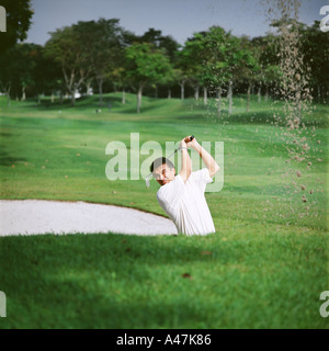 Golfeur en fosse de sable Banque D'Images