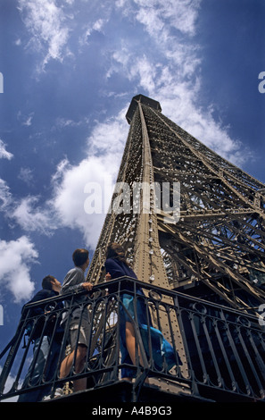 Trois touristes l'ascension de la Tour Eiffel à la recherche jusqu'en haut Paris France Banque D'Images