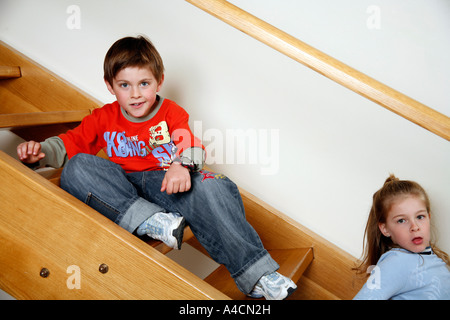 Les enfants fatigués on staircase Banque D'Images