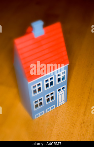 Une maison d'argent en forme de case sur la surface en bois. Image avec peu de profondeur de champ. Banque D'Images