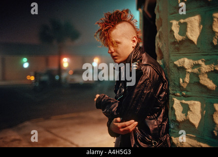 Jeune homme à la coupe mohawk fume une cigarette à l'extérieur d'un autre club discothèque à Jacksonville en Floride USA Banque D'Images