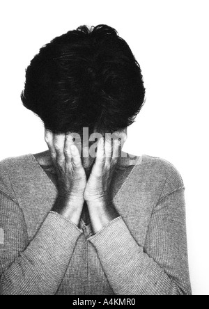 Woman covering her face with hands, portrait, b&w. Banque D'Images