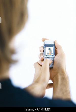 Man holding portable affichage photo de femme Banque D'Images