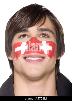 Jeune homme avec drapeau suisse peint sur le visage Banque D'Images