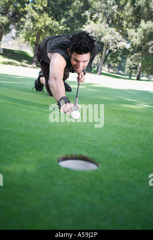 L'homme jouant au billard on Golf Course Banque D'Images