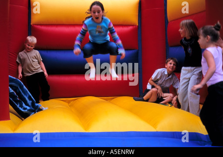 Enfants jouant sur un château gonflable Banque D'Images