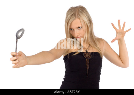 Isolé sur blanc Femme cuillère par force l'esprit de flexion Banque D'Images