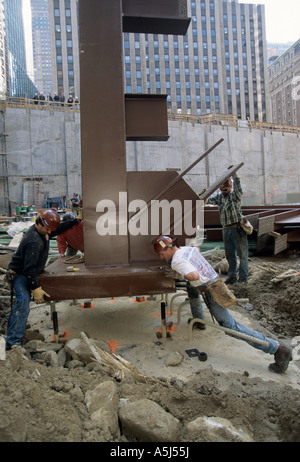 Travailleurs en fer fer 24 000 pound colonne de soutien pour la construction de maisons au hasard à 1540 Broadway à New York City. Banque D'Images