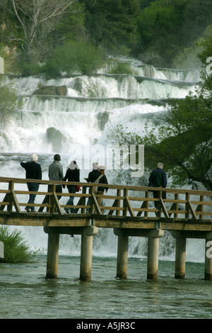 Chutes de Skradin avec touristes traversant la rivière du pont de bois à travers la Croatie Banque D'Images