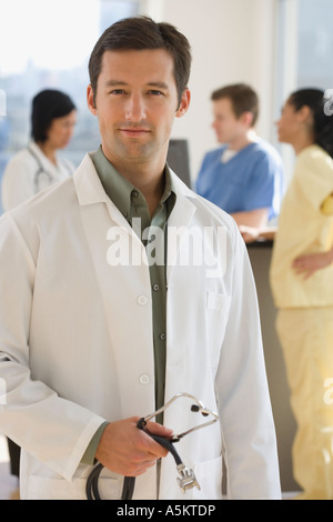 Portrait of male doctor holding stethoscope Banque D'Images