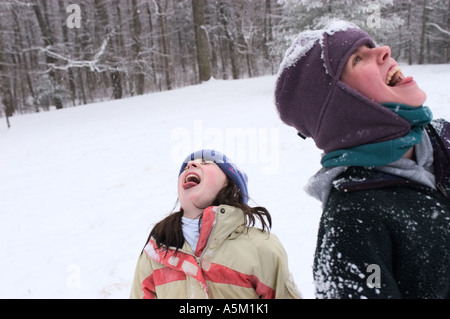 Deux filles sont attraper des flocons avec leurs langues sur un jour d'hiver à Asheville, Caroline du Nord Banque D'Images