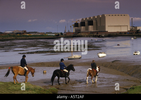 Enfants sur des chevaux de poneys avec chantier naval à Barrow dans Furness Cumbria. Prise de Walney Island à travers Walney Channel. Royaume-Uni années 1980 années 80 HOMER SYKES Banque D'Images