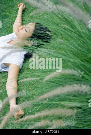 Woman lying on grass Banque D'Images