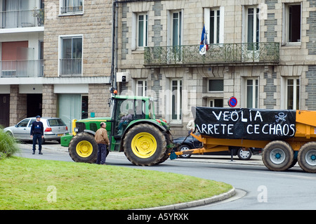 Tracteur avec des slogans de la conduite dans la ville à une manifestation d'agriculteurs dans la ville Morlaix Morlaix en Finistère Bretagne Banque D'Images