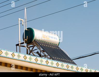 L'énergie solaire powered chauffe-eau chaude réservoir sur toit de maison en milieu rural village agricole de la près de Penglai, dans la province de Shandong, Chine Banque D'Images