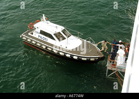 Piloti motor yacht lancer aux côtés de l'équipage des navires de croisière visitant aider pilote Italien de conseil pour aider au départ du port de La Spezia Italie Banque D'Images