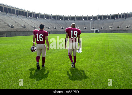 Deux joueurs de football de Harvard à pied dans un stade de Harvard Cambridge, Massachusetts Banque D'Images