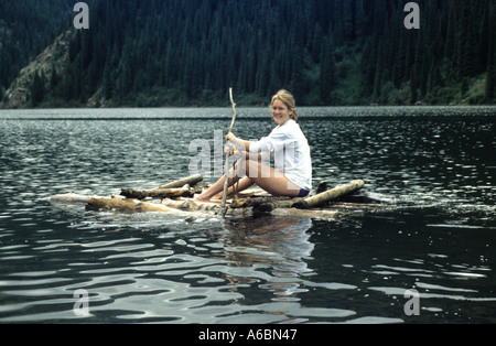 Une jeune femme d'un radeau de fortune des palettes sur Kisoai Lake au Kazakhstan Banque D'Images