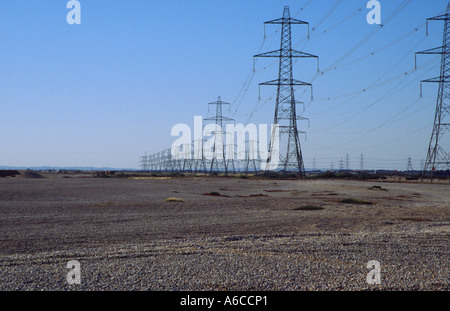 Les lignes électriques s'éloignant de la centrale nucléaire de Dungeness Banque D'Images