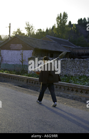 Chine SIMATAI fermier chinois chefs pour ses champs communautaires marchant sur une route de campagne Banque D'Images