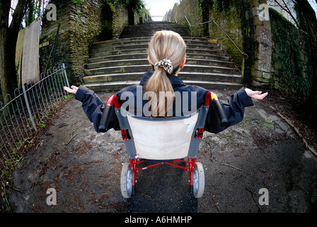 Mobilité woman in wheelchair incapable de monter un grand escalier Banque D'Images