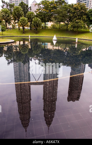 Les Tours Petronas vu comme un reflet dans un étang dans le parc KLCC, Kuala Lumpur, Malaisie. 2006 Banque D'Images