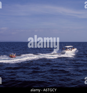 Fun in the sun avec nervure Charter Portal - donuts en remorque derrière Rigid Inflatable Boat - dans la baie de Palma près de Magalluf. Banque D'Images