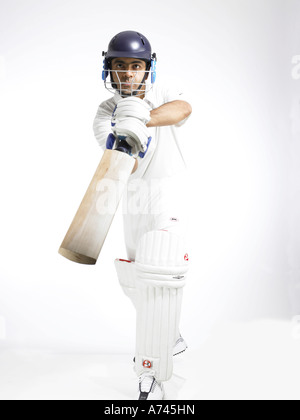 Batteur en action de jouer directement avancer tourné avec cricket sur fond blanc M.# 702A Banque D'Images