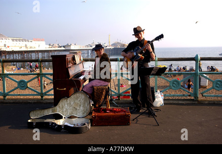 Les amuseurs publics jouant de la guitare et un piano de divertir la foule sur le front de mer de Brighton UK Banque D'Images