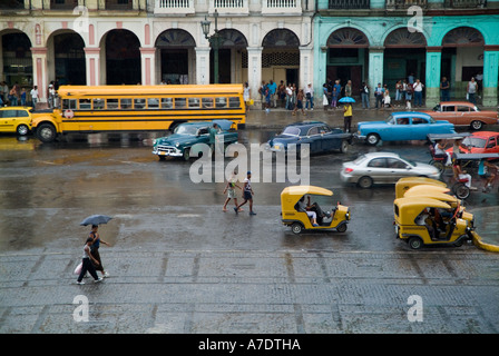 Le trafic sur un jour de pluie près de l'immeuble El Capitalio à La Havane, Cuba. Banque D'Images