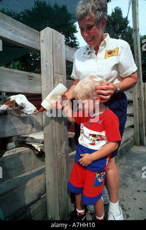 États-unis, Illinois, Chicago. Enfant au biberon une chèvre au Zoo de Brookfield. (MR) Banque D'Images