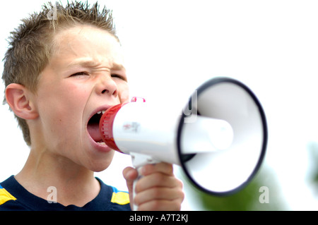 Close-up of teenage boy using megaphone Banque D'Images