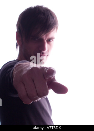 Portrait of young man pointing Banque D'Images