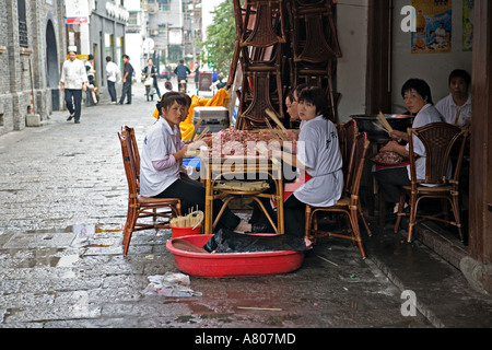 Chine HANGZHOU travailleurs Restaurant shish préparer les brochettes de viande à faire griller au trottoir des grillades dans la vieille ville de Hangzhou Banque D'Images