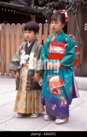 Un garçon de 5 ans et sa sœur de 7 ans posant pour une photo dans un sanctuaire lors d'un événement d'automne appelé Shichigosan, qui signifie 7-5-3, à Tokyo, au Japon. Banque D'Images