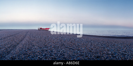 Bateau solitaire sur plage de galets sur la côte de Norfolk vue panoramique Banque D'Images