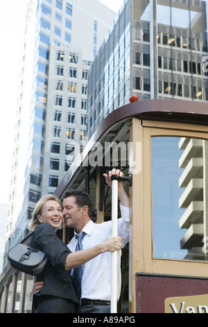 Mature couple riding a street car Banque D'Images