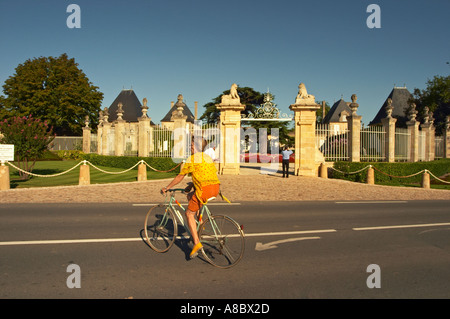 La porte d'entrée au Château Beychevelle à Saint Julien. Un cycliste sur la route en face Banque D'Images