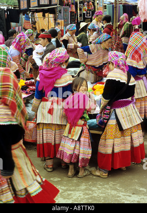 Groupe de femmes Hmong Fleur vêtements traditionnels et une jeune fille au marché le dimanche, Bac Ha, NW Viet Nam Banque D'Images