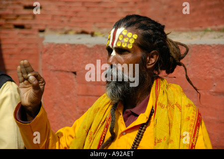 Portrait d'un saint homme sadhu avec une cape jaune et le Népal Katmandou front peint Banque D'Images